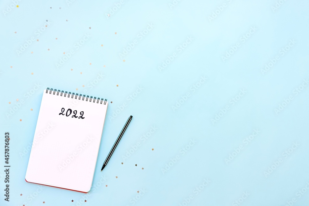 Top view of empty notebook ready for New 2022 Year resolutions or wish list. Copy space.