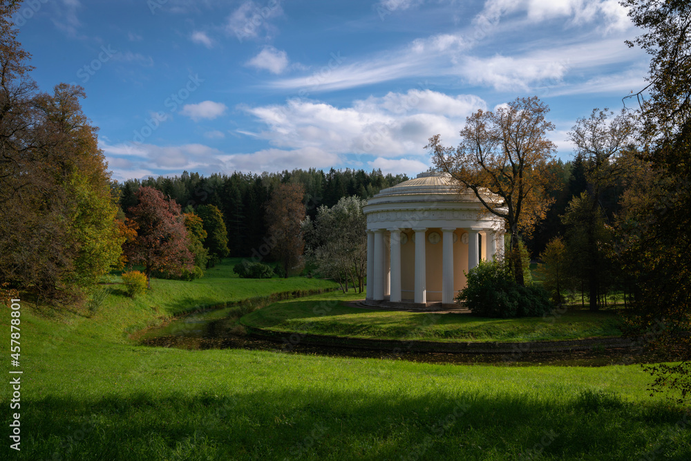 View of the Temple of Friendship on the bank of the Slavyanka River in the Pavlovsky Palace and Park Complex on an autumn sunny morning, St. Petersburg, Russia