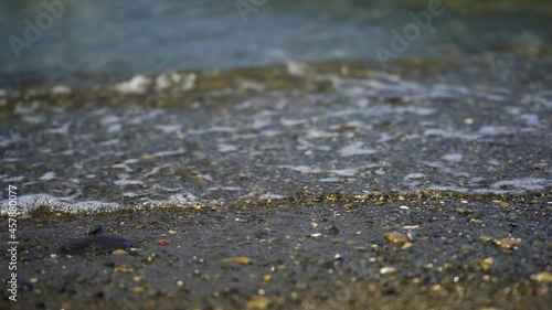 Wallpaper Mural Beautiful view of the azure small waves illuminated by the sun, rolling on the beach Torontodigital.ca