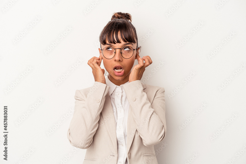Young mixed race woman isolated on white background covering ears with fingers, stressed and desperate by a loudly ambient. Young mixed race woman isolated on white background covering ears with fingers, stressed and desperate by a loudly ambient.
