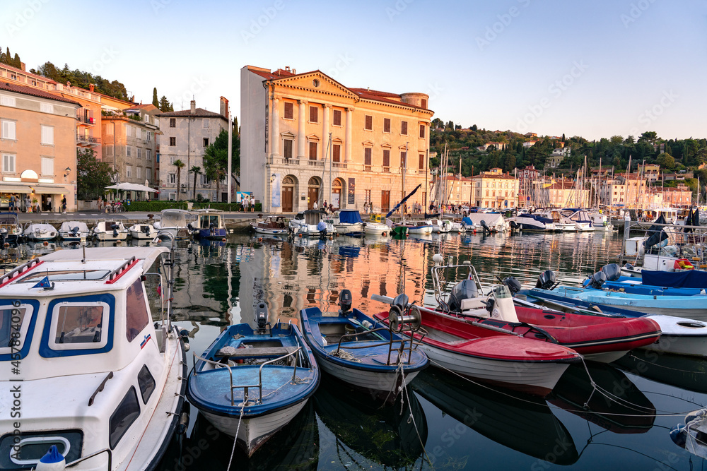 Piran harbour with boats in the sunset
