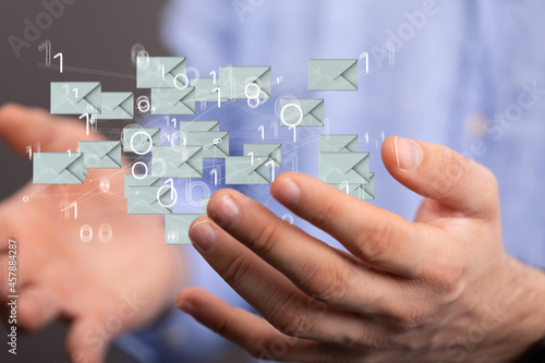 Hand holding using mobile phone with email icon on screen. Concept of business communication