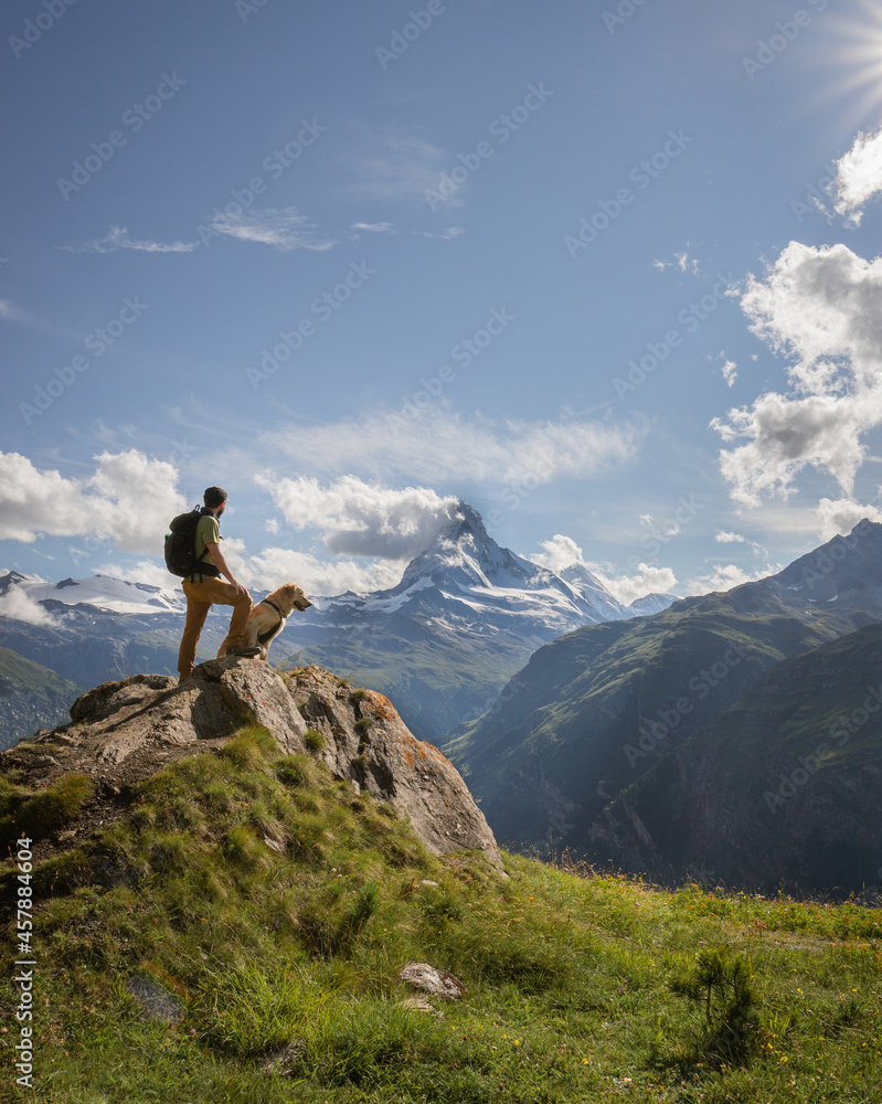 Hiker and dog matterhorn landscape