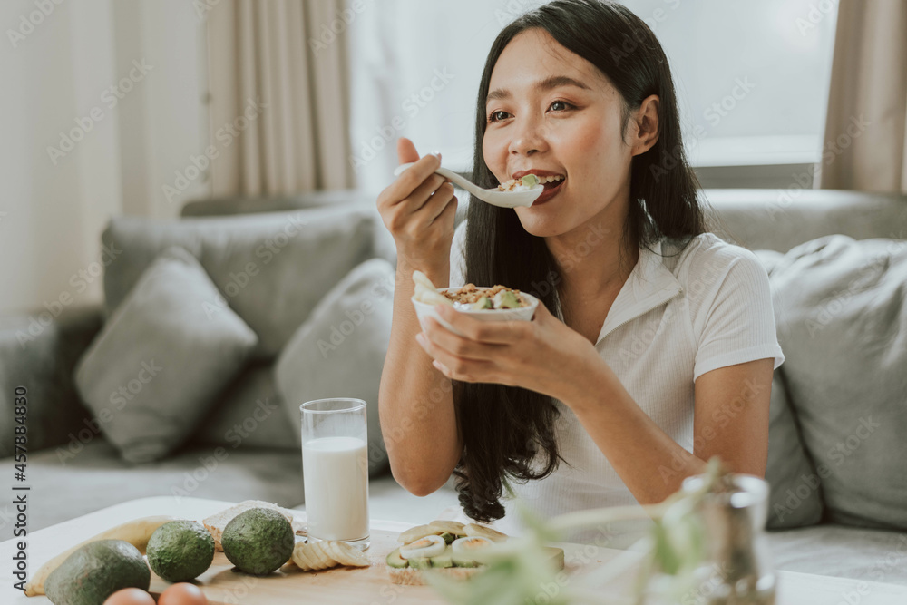 Healthy woman eating healthy food. Young woman cooking healthy food at home. Healthy and wellness concept. Healthy woman eating healthy food. Young woman cooking healthy food at home. Healthy and wellness concept.