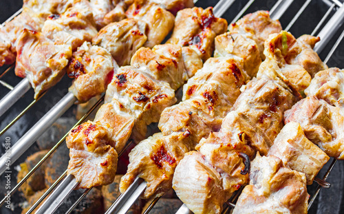 Russian shashlik with skewers on a white plate background.