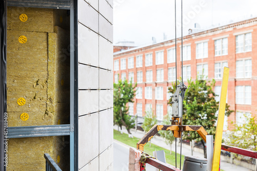 фотографія Installation of ventilated facade tiles and insulation on the building