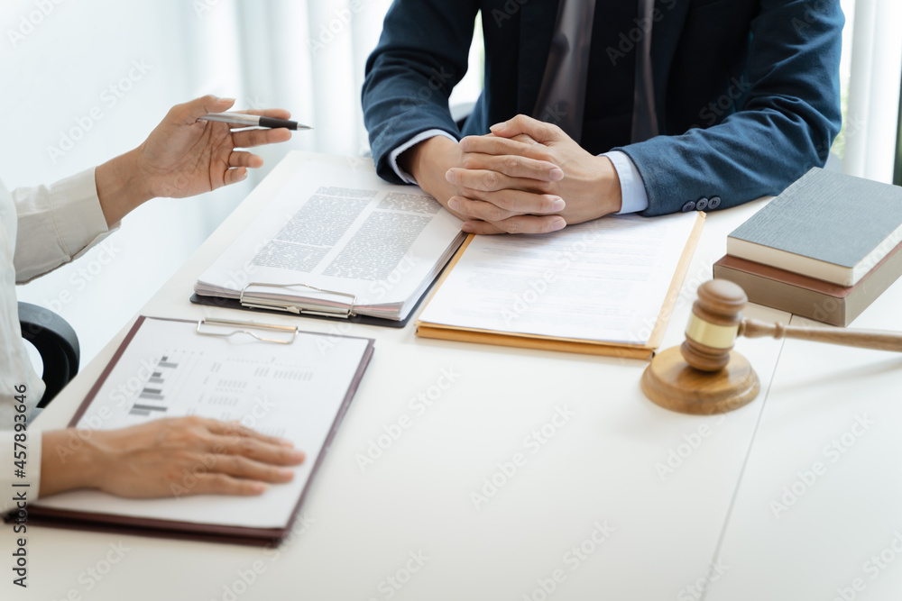 Lawyer Legal counsel presents to the client a signed contract with gavel and legal law. justice and lawyer Business partnership meeting concept. Lawyer Legal counsel presents to the client a signed contract with gavel and legal law. justice and lawyer Business partnership meeting concept.