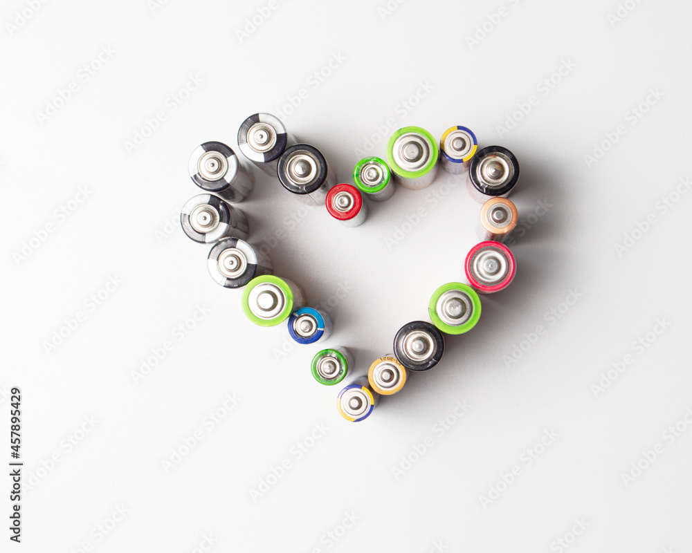 Used batteries are laid out in the shape of a heart. Will be recycled Used batteries are laid out in the shape of a heart. Will be recycled