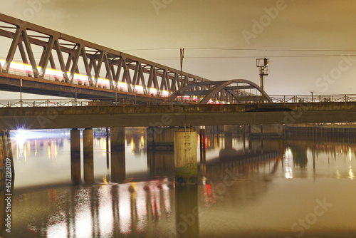 scenic night shot of a railway bridge over a river © Andreas