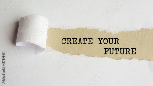create your future. words. text on gray paper on torn paper background