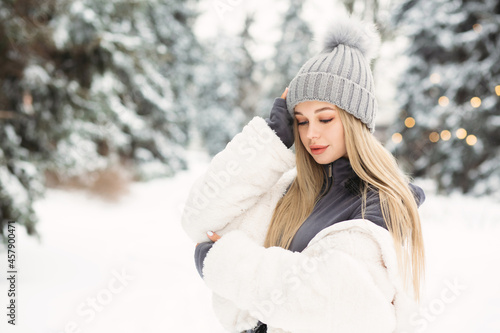 Tender lady walking in the winter forest
