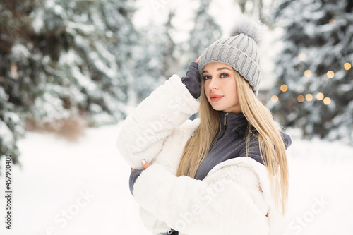 Young lady walking in the winter forest