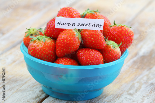 Obraz na płótnie Have a sweet day note with fresh, sweet strawberries in blue plastic bowl
w salonie