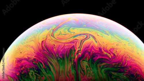 Soap Bubble Ball on black background. Abstract semicircle colorful background. Model of Space or planets universe cosmic. Real macro photo.