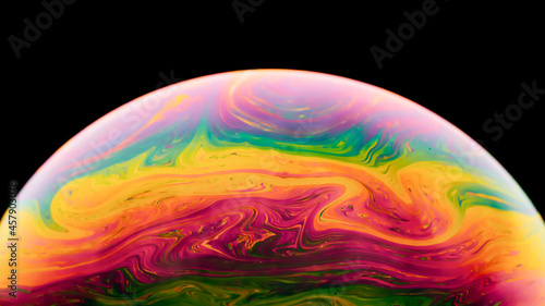 Soap Bubble Ball on black background. Abstract semicircle colorful background. Model of Space or planets universe cosmic. Real macro photo.