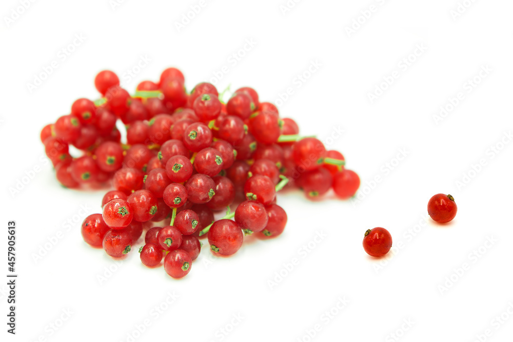 Fresh organic ripe red currant in dew drops in a heap and whole isolated on white background. Fresh organic ripe red currant in dew drops in a heap and whole isolated on white background.
