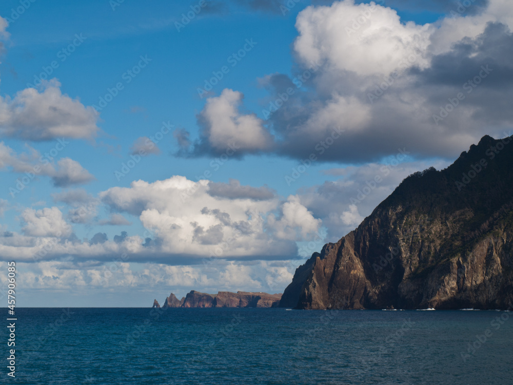 Clouds over Madeira island coastline with blue sky Clouds over Madeira island coastline with blue sky