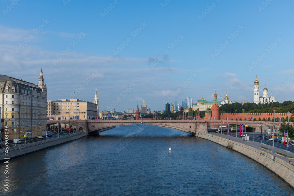 Cityscape of Moscow city downtown district in Russia with Moscow Kremlin, Moskva river and Moskvoretskaya Embankment. Blue sky with few clouds. Travel in Russia theme.