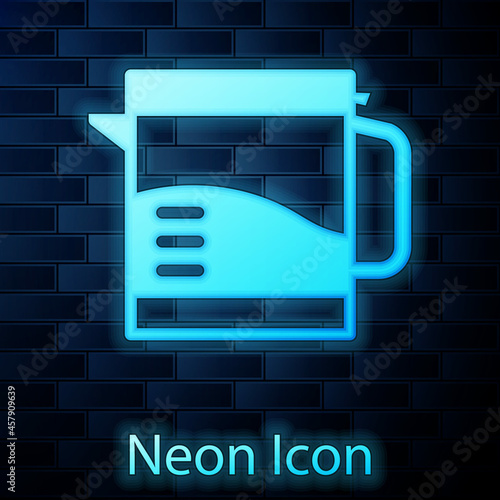 Glowing neon Electric kettle icon isolated on brick wall background. Teapot icon. Vector