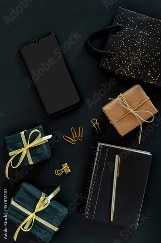 cellphone with gift box and shopping bag black friday concept. © Marcela Ruty Romero