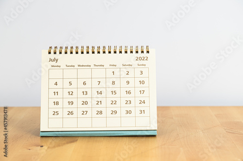 Fototapeta Naklejka Na Ścianę i Meble -  July, 2022 calendar on wooden table