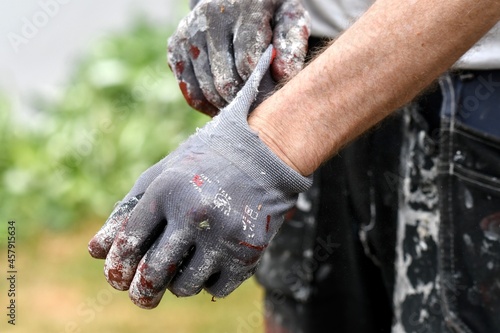 A man putting on protective gloves for painting