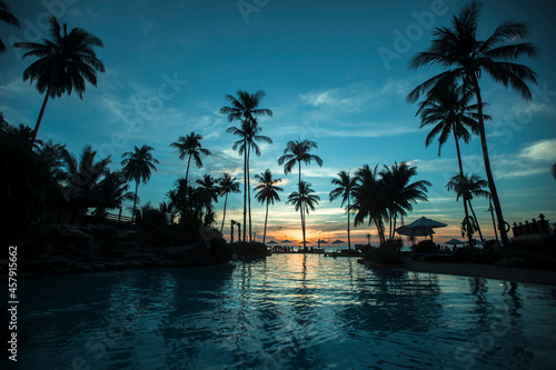 Silhouettes of the palm trees at tropical beach during paradise sunset. © De Visu