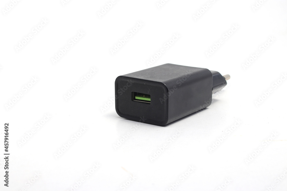 Black Cell Phone Charger Adapter with a green micro USB quick charge on hand isolated on white background Black Cell Phone Charger Adapter with a green micro USB quick charge on hand isolated on white background