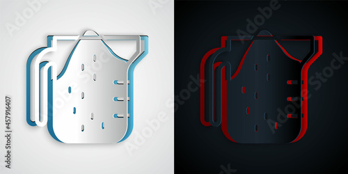 Paper cut Measuring cup to measure dry and liquid food icon isolated on grey and black background. Plastic graduated beaker with handle. Paper art style. Vector