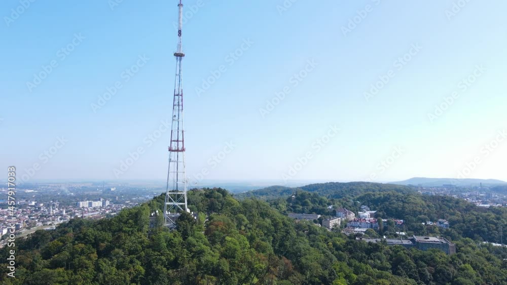 Aerial view of the large TV tower on the mountain in the urban area Aerial view of the large TV tower on the mountain in the urban area