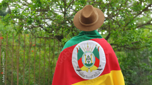 Young person with hat and flag of the state of Rio Grande do Sul - Southern Brazil. Farroupilha Week of the Gauchos.