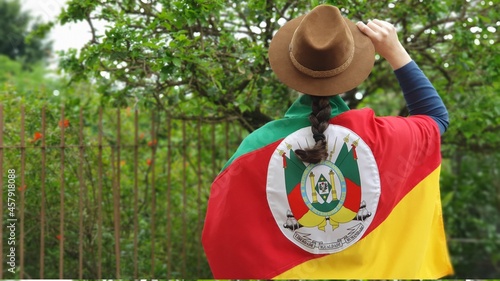 Brazilian woman with hat and flag of the state of Rio Grande do Sul - Sul do Brasil. Farroupilha Week of the gauchos.