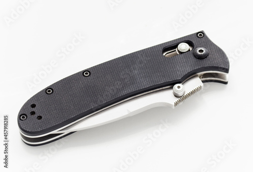 Folding knife in a folded position on a white background