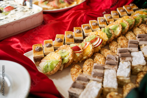 photo of a variety of small cakes on the buffet