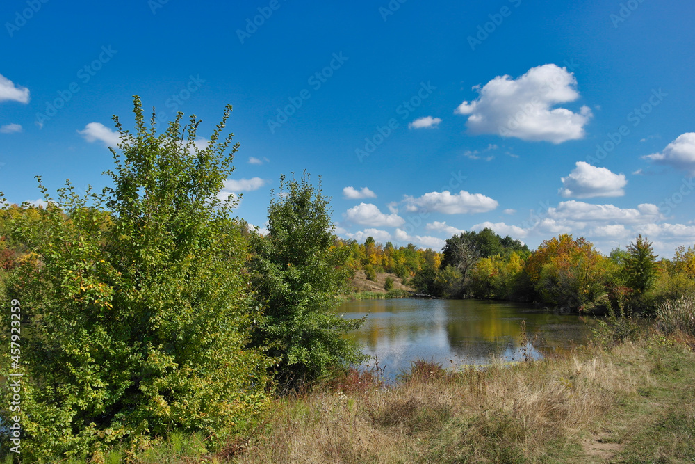 Autumn landscape with lake and trees, lake in the forest Autumn landscape with lake and trees, lake in the forest