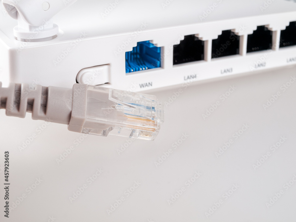 internet cable close-up on the background of a Wi-Fi router, close-up, cable and wireless internet, lan cable, Gigabit Ethernet internet cable close-up on the background of a Wi-Fi router, close-up, cable and wireless internet, lan cable, Gigabit Ethernet