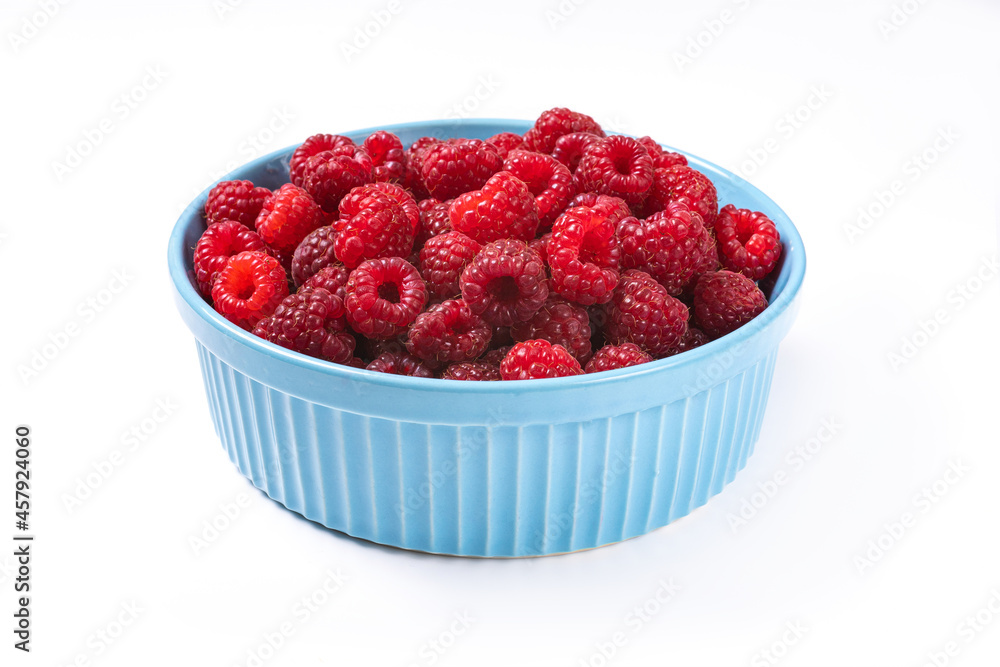 Red raspberry berry in plate on wooden table. Red raspberry berry in plate on wooden table.