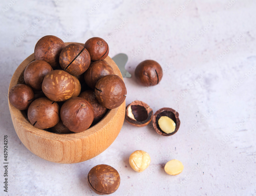 Fototapeta premium natural organic macadamia nuts in a wooden bowl