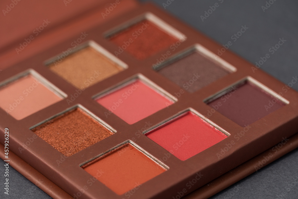 Fototapeta premium Artistic photography of cosmetics. Eye shadows on a grey background