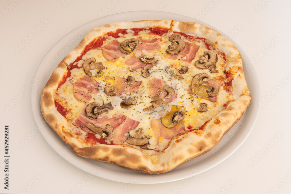 Italian Mushroom Pizza with Cheese and Smoked Bacon with Oregano and Olive Oil Cooked in a Stone Oven