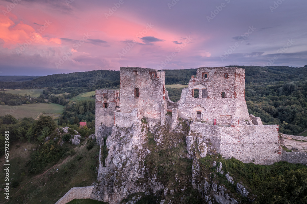 Aerial view of ruined Gothic Csesznek castle in the Bakony region of Hungary in Veszprem county with old palace building, gate tower with colorful dramatic sunset Aerial view of ruined Gothic Csesznek castle in the Bakony region of Hungary in Veszprem county with old palace building, gate tower with colorful dramatic sunset