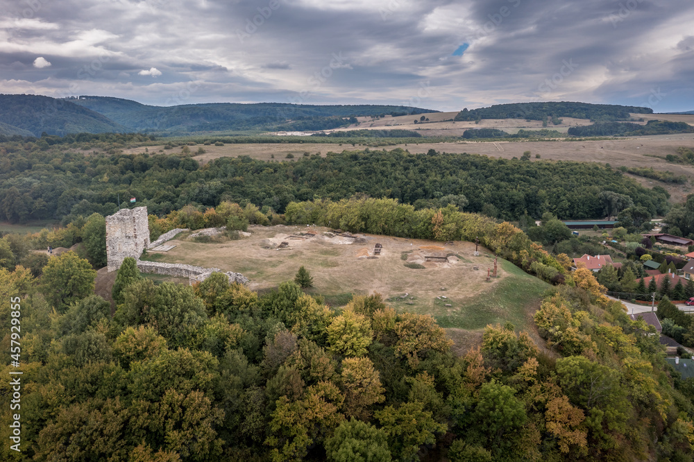Aerial view of ruined medieval Gothic castle Essegvar on a hilltop above Band in Veszprem county, Bakony mountains Hungary with partially restored square tower and excavation digs on the courtyard