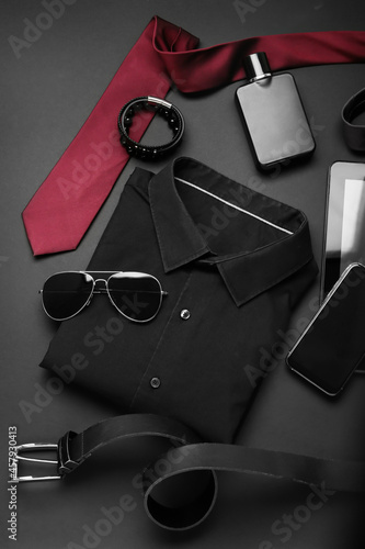 Stylish male clothes and accessories on dark background