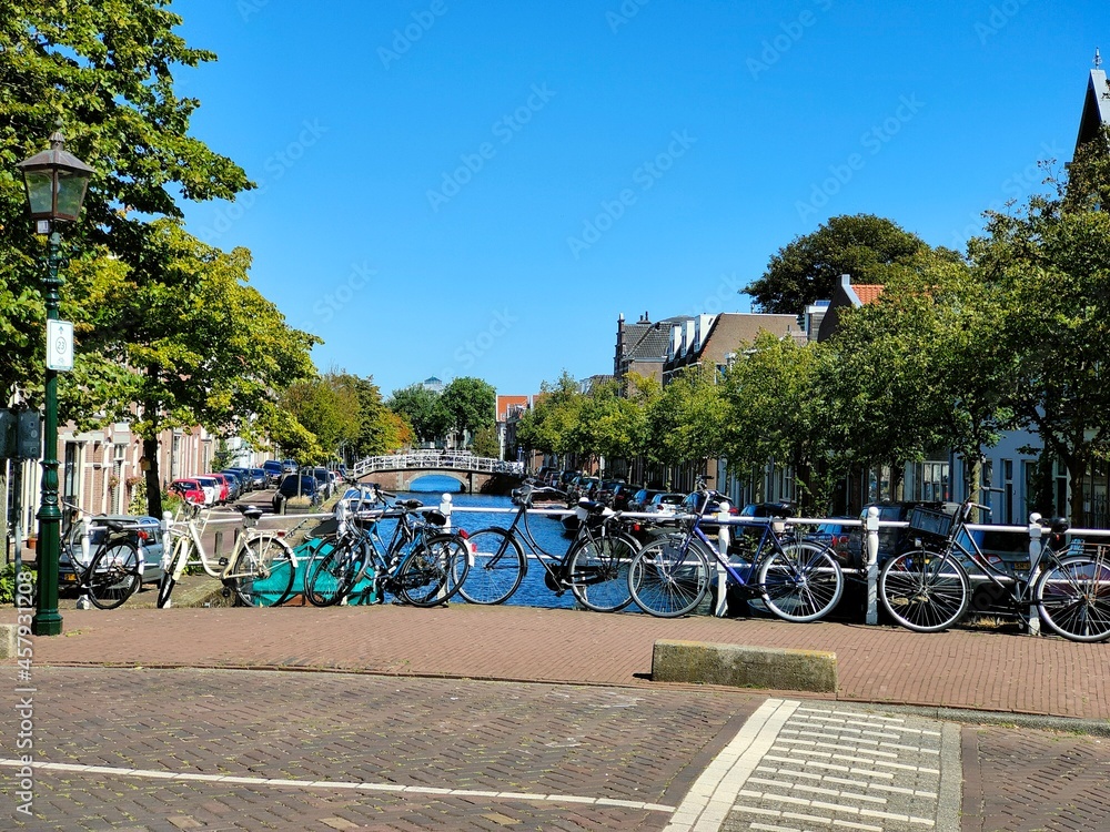 Haarlem, Amsterdam, Netherlands - September 2021 - Water channel in city center. Bridge with parked bikes.