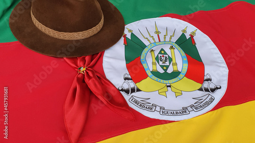 Cuadro en lienzo Hat, red gaucho scarf and State Flag of Rio Grande do Sul - Brazil, on the table