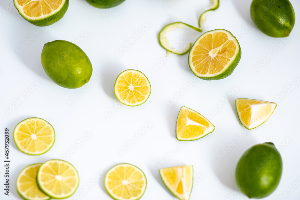 Flat lay view green lime lemons over isolated white backdrop.Includes copy space.