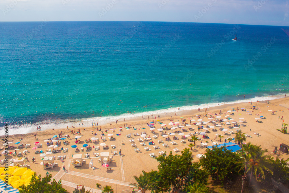 Beach in Alanya, Turkey. View and heights, top view. Blue sea in summer. Vacation in Turkey. Cleopatra beach.