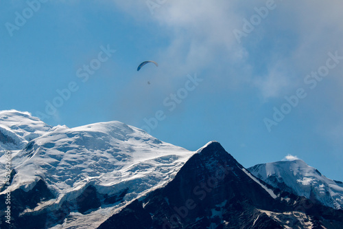 A tiny figure of a paraglider in the French Alps. The view towards Mont Blanc from a hiking trail between Les Houches and Refuge de Bellachat (near Chamonix).