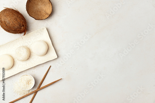 Tray with tasty Japanese mochi and chopsticks on light background