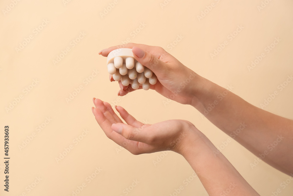 Female hands with massage soap bar on color background Female hands with massage soap bar on color background
